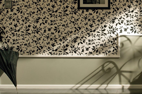 Decorative moulding here separates a wall that has been painted and wallpapered